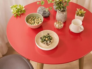 A red table with a white plate of food on it