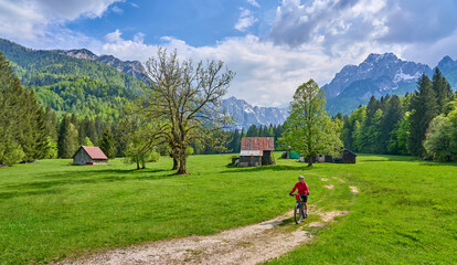 active senior woman on a mountain bike tour in the Julian Alps above Kranska Gora in Slovenia
