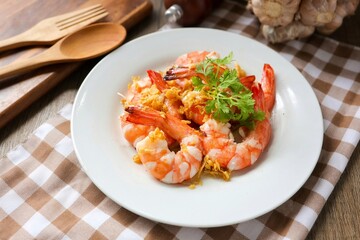 Stir Fried Shrimps with Garlic on white ceramic plate, home cook	