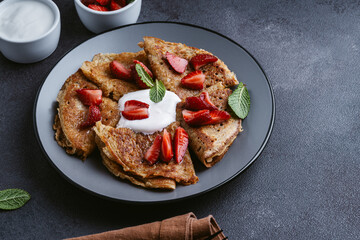 Sweet whole grain crepes with strawberry and sour cream