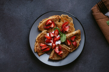 Sweet whole grain crepes with strawberry and sour cream
