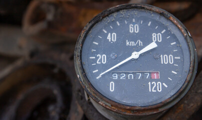 Close-up of an old analog speedometer with a classic dial