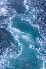 A dramatic natural scene of the Naruto Whirlpools as seen from a viewpoint near the O-naruto Bridge in Tokushima, Japan.