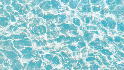 Blue Water SurfaceClear turquoise water surface with sunlight reflections and ripples.