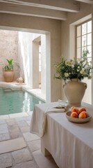 Rhodes inner courtyard with dipping pool, white linen cloth, ceramic vase with peaches and pale stone floor