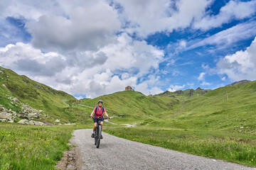 nice active senior woman riding her electric mountain bike in the silvretta mountain range near Gaschurn, Tyrol, Austria