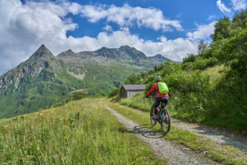 Fototapeta premium nice active senior woman riding her electric mountain bike in the silvretta mountain range near Gaschurn, Tyrol, Austria