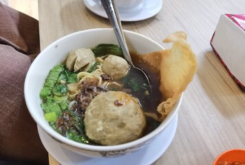 A portion of meatballs with hot and tasty gravy