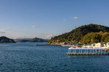 Ferry Approaching Naoshima Island during Tranquil Evening Light, Setouchi, Japan