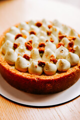Delicious homemade cheesecake topped with creamy frosting and crunchy cookie bits