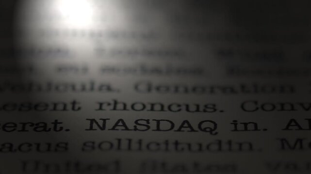NASDAQ stock exchange. The topic of economy.  Moving text printed on a page. Headline. A piece of paper with a phrase written in retro typewriter font. Spotlight effect. Dramatic video. NYC