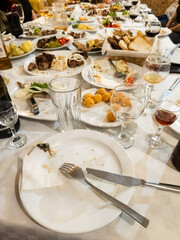 A table full of plates of food and glasses of wine