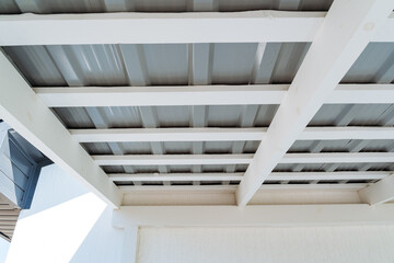 As I gaze up at the intricate and sturdy ceiling of a large building, I notice its metallic roof...