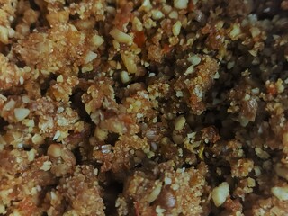 Detailed view of a crunchy snack with nut and grain texture.