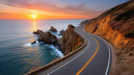 Serene Coastal Road During Vibrant Sunset Overlooking Ocean Waves
