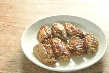 grilled salty and spicy chicken wing with black pepper on plate