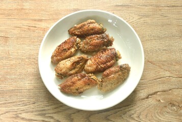 grilled salty and spicy chicken wing with black pepper on plate