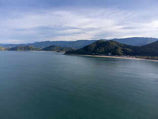 Beautiful coastal village with beautiful green water beach and tropical mountains around