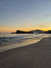 amazing red sunset among the rocks on a tropical beach