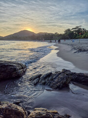amazing red sunset among the rocks on a tropical beach