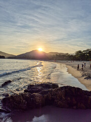 amazing red sunset among the rocks on a tropical beach