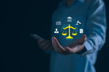 Businessman holding digital legal icon with law symbols, representing tech, compliance, advice...