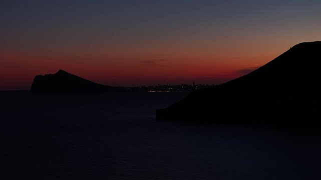Aerial view of Calp city and Estimar hotel at twilight with dark silhouettes, Calp, Spain.