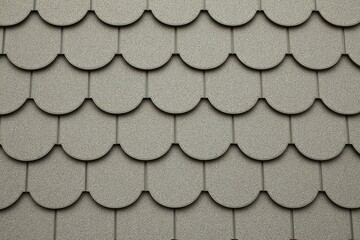 Fototapeta premium Detailed Roofing Texture: A close-up shot revealing a seamless, meticulously crafted pattern of weathered roof tiles, highlighting the artistry and durability inherent in residential architecture.