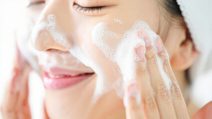 Asian Woman's Face Skincare Routine: Cleansing with Gentle Foam Cleanser for Fresh, Healthy Skin. Beauty Ritual, Daily Hygiene, Spa Self-Care Concept.