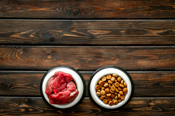 Pet food in bowls - meat and dry food, top view