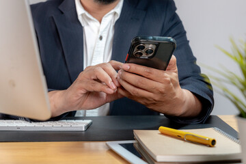 Close-up of a professional using a mobile phone — digital tools in corporate life