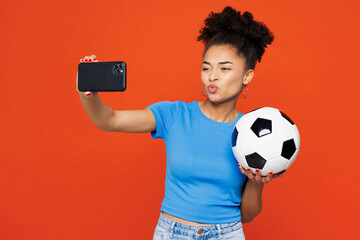 Young happy woman fan wear basic blue t-shirt cheer up support football sport team hold soccer ball...