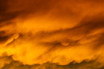 A large orange cloud with a white streak