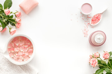 Spa organic cosmetic products with roses essential oil on white background top view