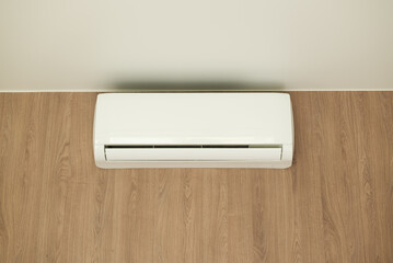Air conditioner of white color on wall background, split-system in apartment