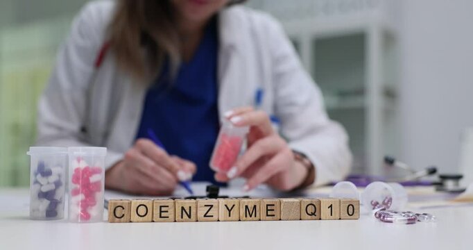 Doctor writes prescription for Coenzyme Q10 while holding container of capsules. Importance of nutrition and wellness in patient care and treatment