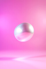 A shiny, floating pearl sphere against a vibrant pink background, creating a modern and abstract visual effect.