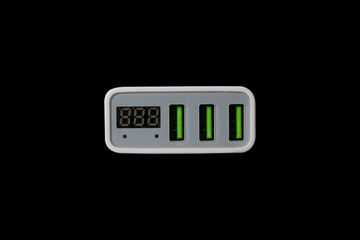 USB adapter for charging multiple mobile phones and modern devices on a black background