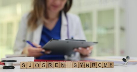 Female professional documents Sjogren Syndrome disease sitting at desk in hospital cabinet. Importance of accurate health assessments for patients