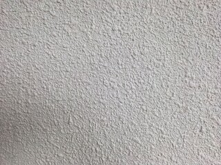 Obraz premium Close-up of rough textured white painted wall surface.