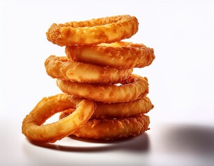 a tower of golden crispy onion rings on a white or clear surface white background