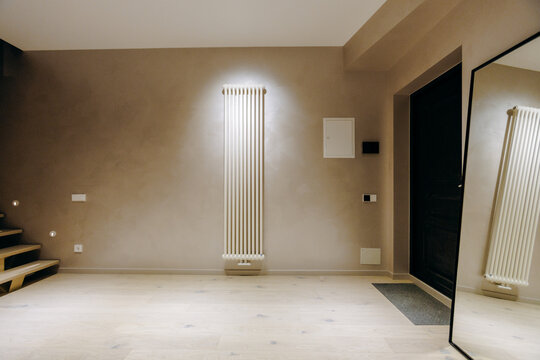 In the center of the room, there is a large, reflective mirror