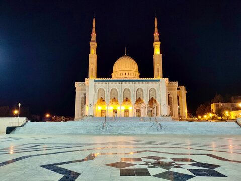 Panoramic night view of the Emir Abdelkader Mosque in Constantine, Algeria. With its towering minarets and elegant domes, the mosque stands as a symbol of Islamic architecture and national pride