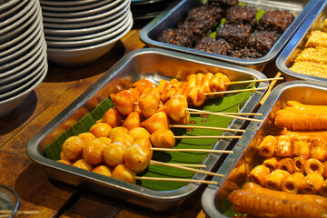 Assorted Satay, Indonesia, captured on May 29, 2025. A traditional Indonesian dish featuring skewered and grilled meat varieties served with spicy peanut sauce, soy glaze, and fresh side dishes