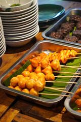 Assorted Satay, Indonesia, captured on May 29, 2025. A traditional Indonesian dish featuring skewered and grilled meat varieties served with spicy peanut sauce, soy glaze, and fresh side dishes
