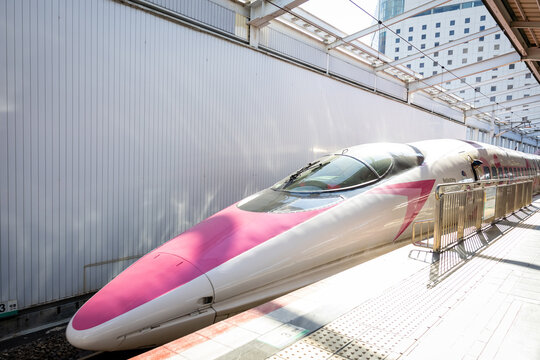 Japan - December 2024: Hello Kitty Shinkansen, a themed bullet train operated by JR West, stands at the platform in Japan. Decorated with pink accents and Hello Kitty designs both inside and outside.