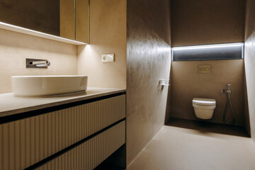 A bathroom featuring a sink, toilet, and mirror for everyday use