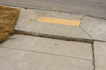 Uneven concrete sidewalk from shifting ground creating trip hazard for pedestrians.