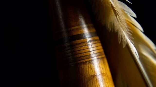 Close-up of a decorated wooden arrow shaft with attached feathers