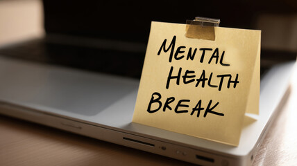 A call for a Mental Health Break on a sticky note placed on a laptop
